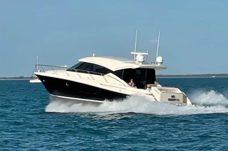 The Image of 2016 Tiara Yachts 50 Coupe cruising on open water under clear skies. - 0