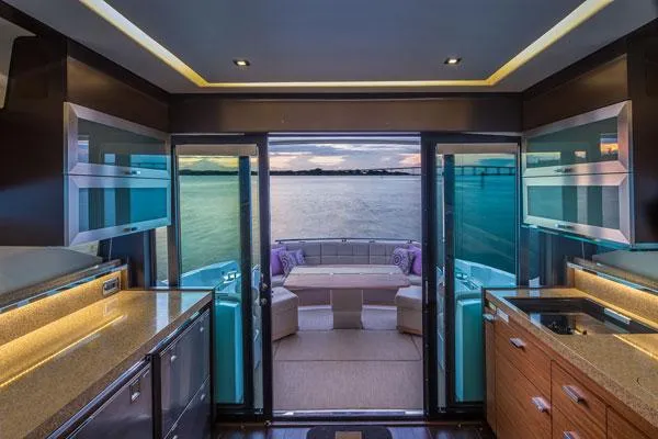 Slide: The Image of Manufacturer Provided Image: Interior of 2016 Tiara Yachts 50 Coupe with ocean view through glass doors. - 12