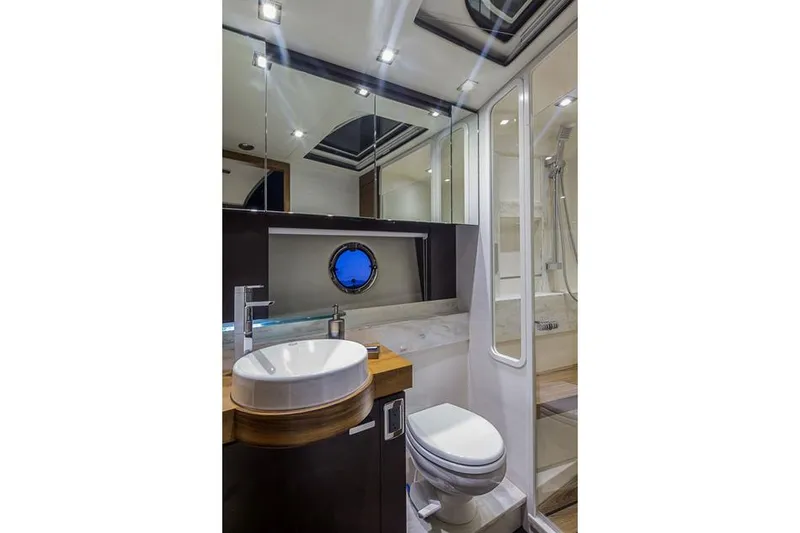 Slide: The Image of Manufacturer Provided Image: Modern bathroom in 2016 Tiara Yachts 50 Coupe with vessel sink and porthole window. - 16