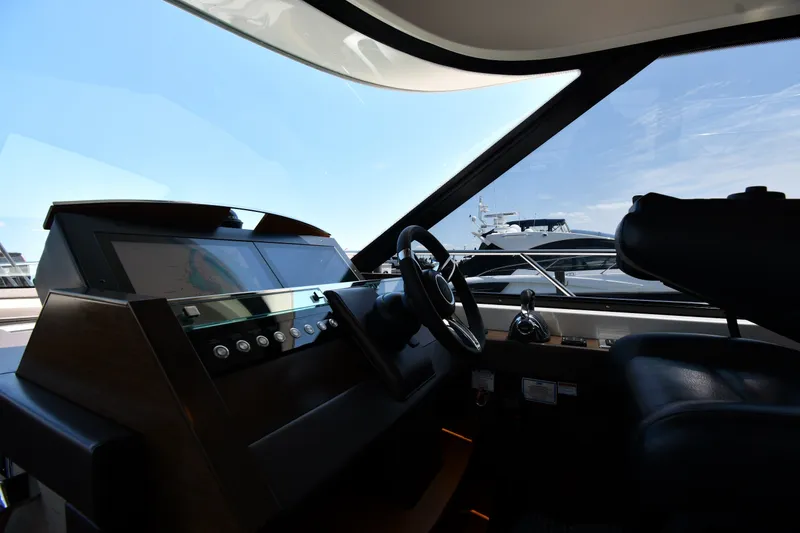 Slide: The Image of Interior helm of 2016 Tiara Yachts 50 Coupe with modern controls and steering wheel. - 56