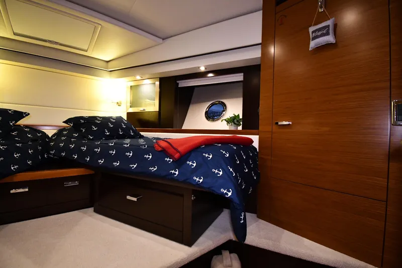 Slide: The Image of Luxurious cabin interior of 2016 Tiara Yachts 50 Coupe with nautical-themed bedding. - 18
