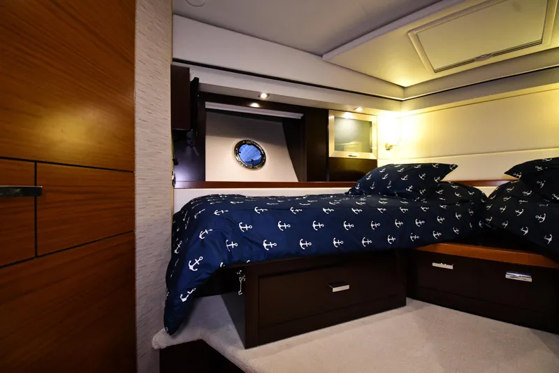 Slide: The Image of Luxurious cabin interior of 2016 Tiara Yachts 50 Coupe with nautical-themed bedding. - 19