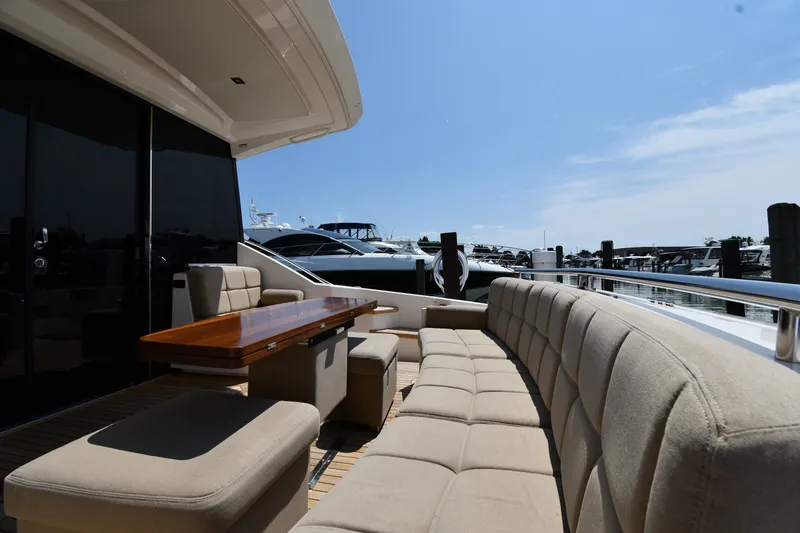 Slide: The Image of Luxurious 2016 Tiara Yachts 50 Coupe with elegant outdoor seating at marina. - 11