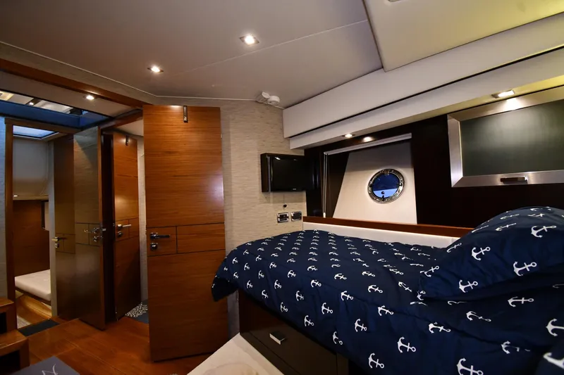 Slide: The Image of Luxurious 2016 Tiara Yachts 50 Coupe cabin interior with nautical-themed bedding. - 20