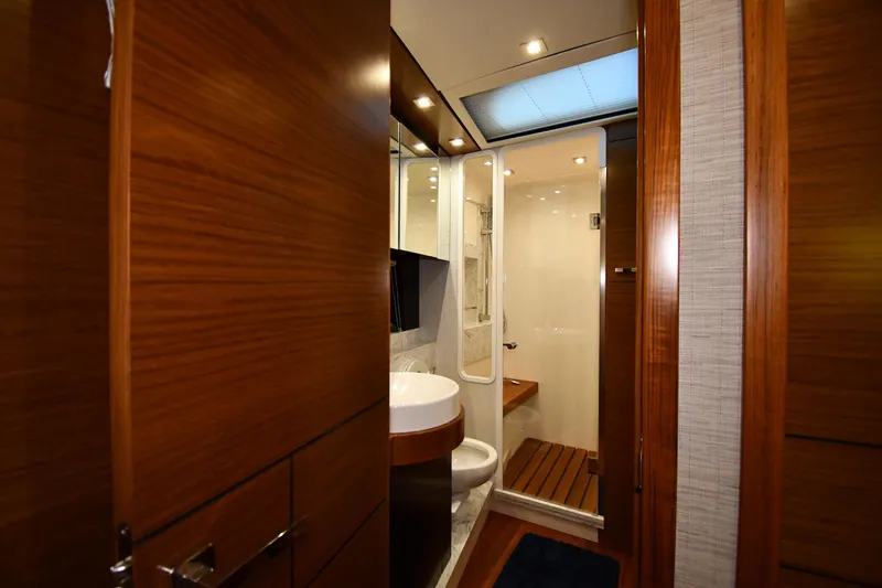Slide: The Image of Luxurious bathroom interior of 2016 Tiara Yachts 50 Coupe, featuring wood accents and modern fixtures. - 24