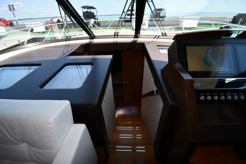 Slide: The Image of Interior view of 2016 Tiara Yachts 50 Coupe helm with navigation display and leather seating. - 22