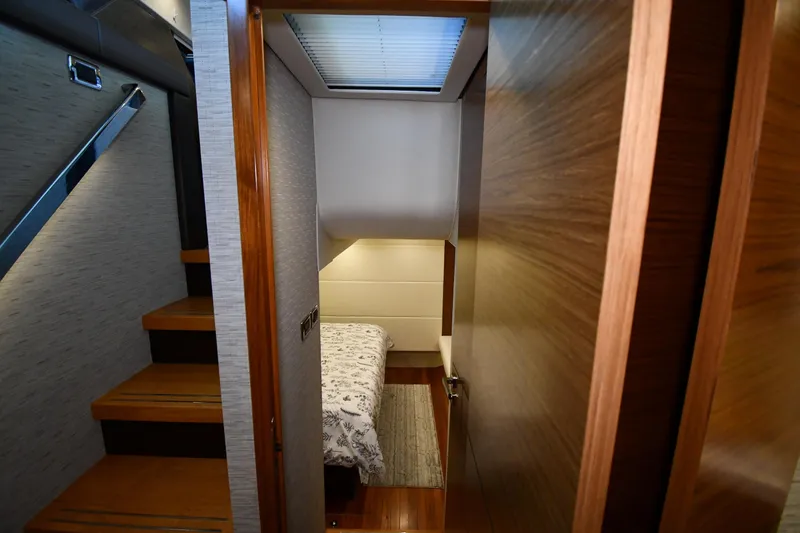Slide: The Image of Interior cabin of 2016 Tiara Yachts 50 Coupe, featuring wooden stairs and cozy bedding. - 27