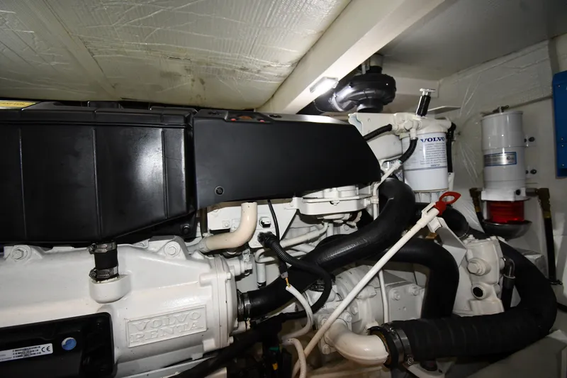 Slide: The Image of Engine compartment of a 2016 Tiara Yachts 50 Coupe, featuring a Volvo Penta engine. - 68