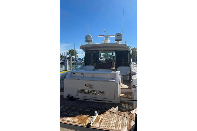 Slide: The Image of 2016 Tiara Yachts 50 Coupe at dock, rear view with "No Regrets" nameplate. - 3