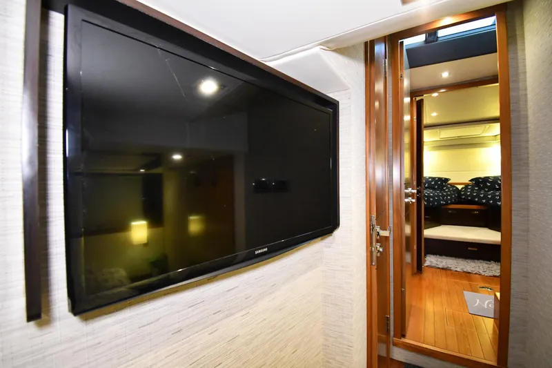 Slide: The Image of Interior of 2016 Tiara Yachts 50 Coupe with TV and cozy cabin view. - 31