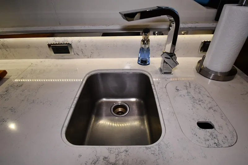 Slide: The Image of Modern kitchen sink with marble countertop on 2016 Tiara Yachts 50 Coupe. - 38