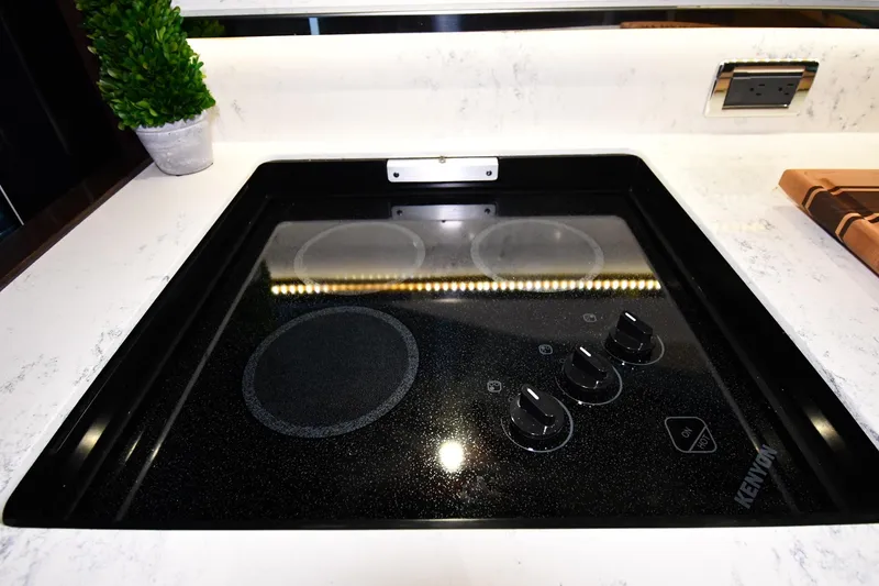 Slide: The Image of Electric stovetop in 2016 Tiara Yachts 50 Coupe kitchen, featuring sleek design and modern controls. - 39
