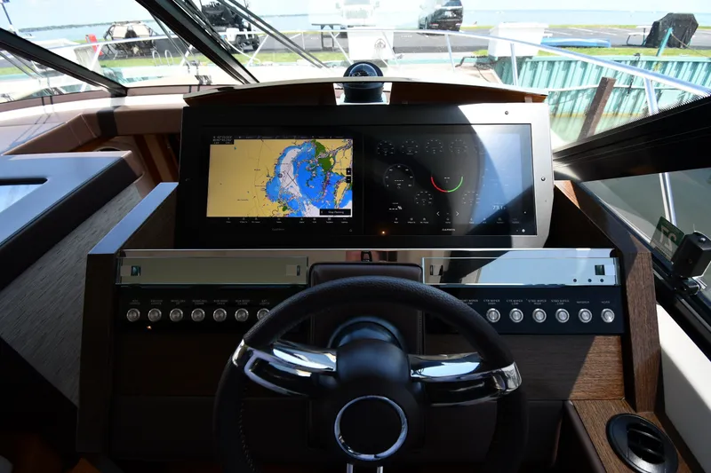 Slide: The Image of Helm of 2016 Tiara Yachts 50 Coupe with navigation screens and controls. - 61