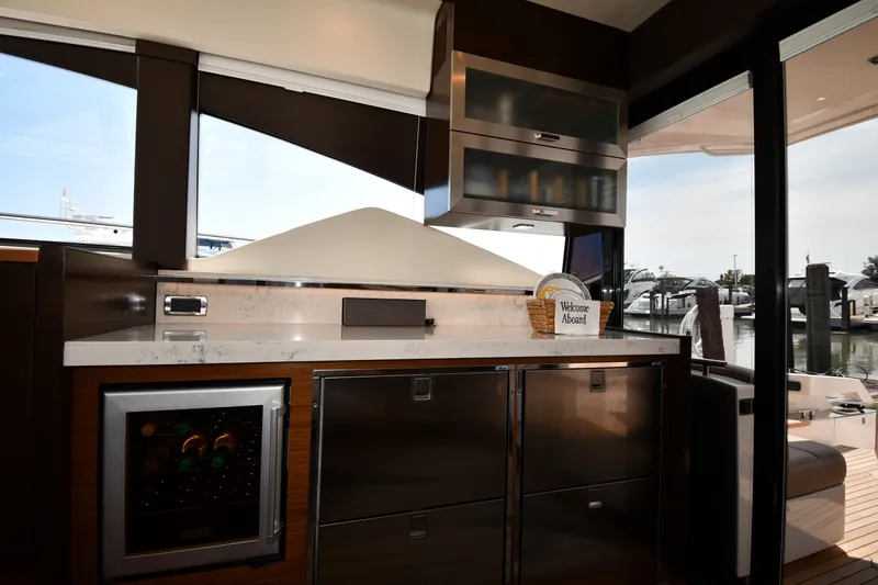 Slide: The Image of Interior of 2016 Tiara Yachts 50 Coupe with modern kitchen and marina view. - 45