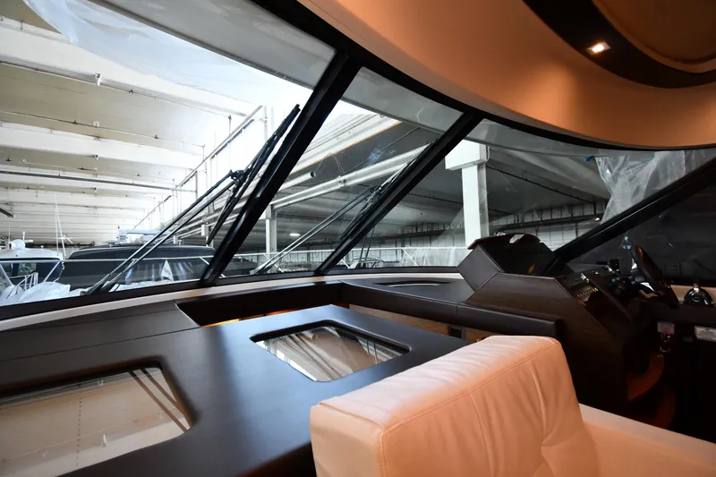 Slide: The Image of Interior view of 2016 Tiara Yachts 50 Coupe, showcasing helm and large windows. - 45