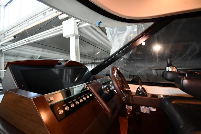 Slide: The Image of Interior helm of 2016 Tiara Yachts 50 Coupe, featuring modern controls and steering wheel. - 46