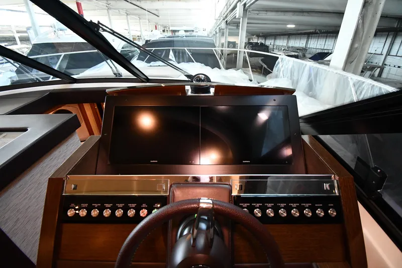 Slide: The Image of Helm of 2016 Tiara Yachts 50 Coupe with dual screens and controls. - 47