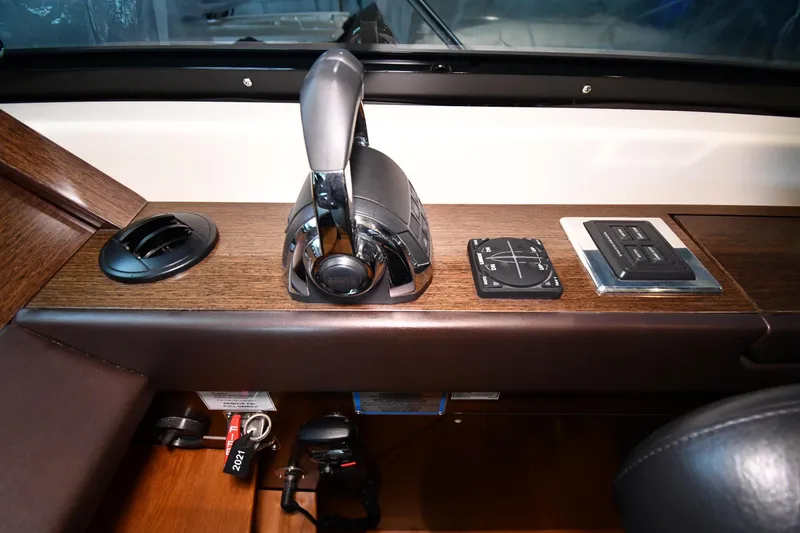 Slide: The Image of Control panel of a 2016 Tiara Yachts 50 Coupe, featuring throttle and navigation controls. - 48