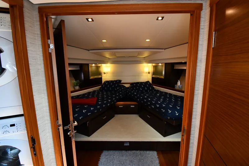 Slide: The Image of Luxurious bedroom interior of 2016 Tiara Yachts 50 Coupe with nautical-themed bedding. - 23