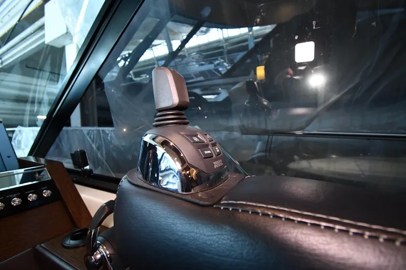 Slide: The Image of Joystick control in the cockpit of a 2016 Tiara Yachts 50 Coupe. - 49