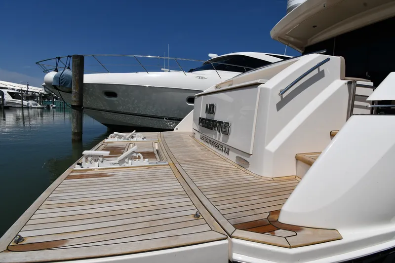 Slide: The Image of 2016 Tiara Yachts 50 Coupe docked, showcasing sleek design and spacious deck. - 4