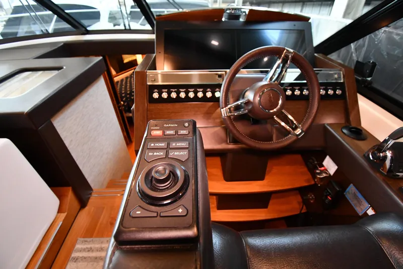 Slide: The Image of Helm of 2016 Tiara Yachts 50 Coupe with modern controls and steering wheel. - 50