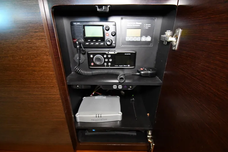 Slide: The Image of Control panel inside 2016 Tiara Yachts 50 Coupe, featuring communication and navigation equipment. - 52