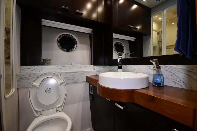 Slide: The Image of Luxurious bathroom in 2016 Tiara Yachts 50 Coupe with modern fixtures and marble accents. - 53