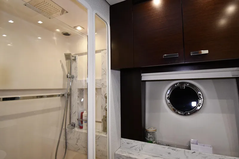 Slide: The Image of Luxurious bathroom interior of 2016 Tiara Yachts 50 Coupe with shower and porthole. - 54