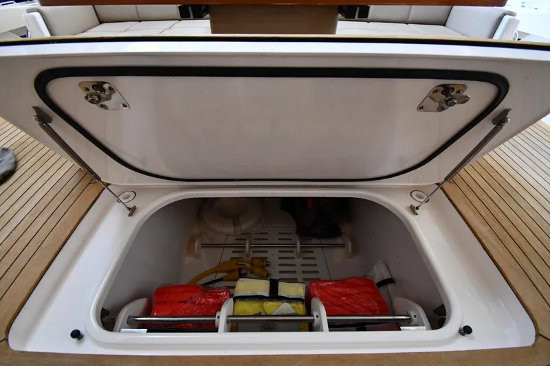 Slide: The Image of Open storage compartment on 2016 Tiara Yachts 50 Coupe, showcasing interior equipment. - 55