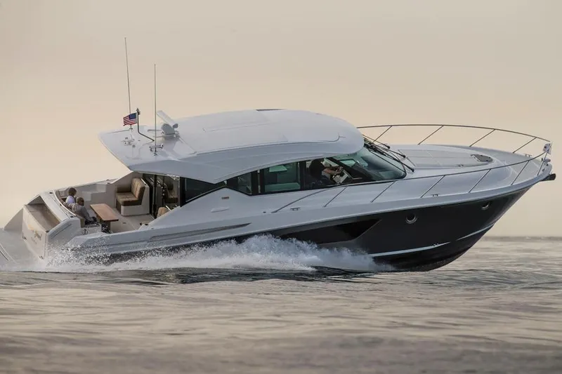 Slide: The Image of Manufacturer Provided Image: 2016 Tiara Yachts 50 Coupe cruising on water at sunset. - 6