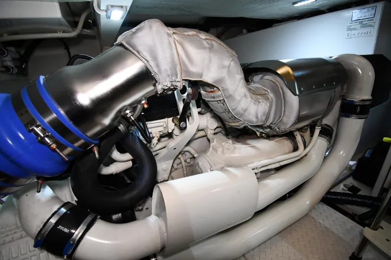 Slide: The Image of Engine room of 2016 Tiara Yachts 50 Coupe, showcasing complex piping and components. - 60