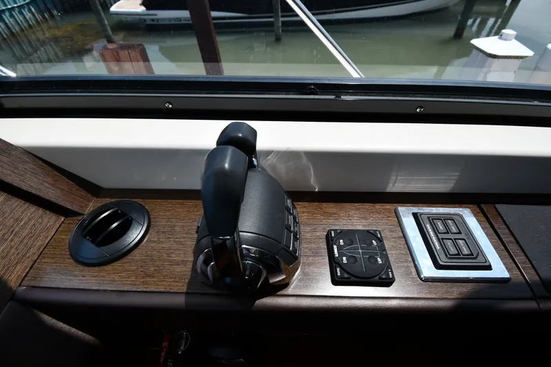 Slide: The Image of Control panel of a 2016 Tiara Yachts 50 Coupe, featuring throttle and navigation controls. - 60