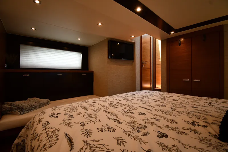 Slide: The Image of Luxurious bedroom interior of 2016 Tiara Yachts 50 Coupe, featuring elegant wood finishes and modern lighting. - 37