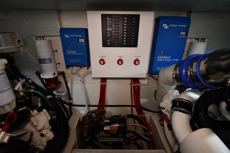Slide: The Image of Engine room of 2016 Tiara Yachts 50 Coupe with electrical panel and battery chargers. - 64