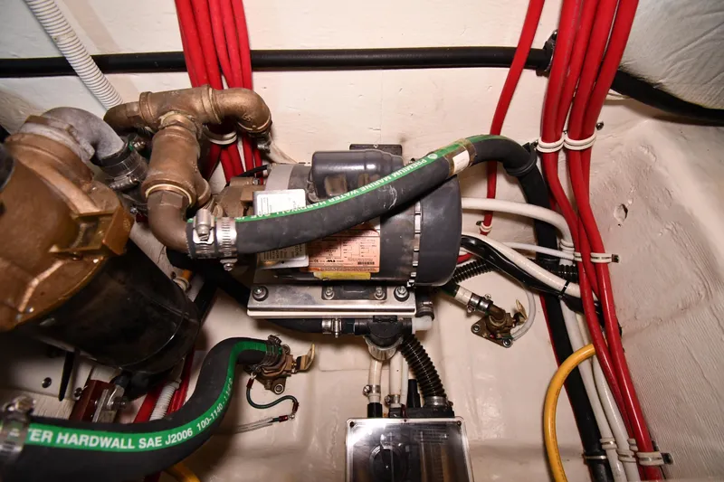 Slide: The Image of Engine room of 2016 Tiara Yachts 50 Coupe with visible hoses and wiring. - 65