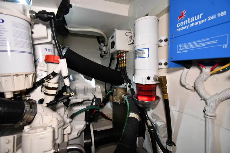 Slide: The Image of Engine room of 2016 Tiara Yachts 50 Coupe with battery charger and filters. - 66