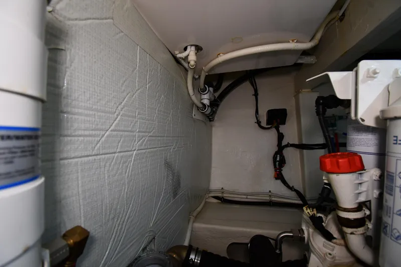 Slide: The Image of Engine room of 2016 Tiara Yachts 50 Coupe, showcasing pipes and mechanical components. - 67