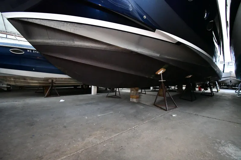 Slide: The Image of 2016 Tiara Yachts 50 Coupe in dry dock, showcasing hull design and structure. - 68