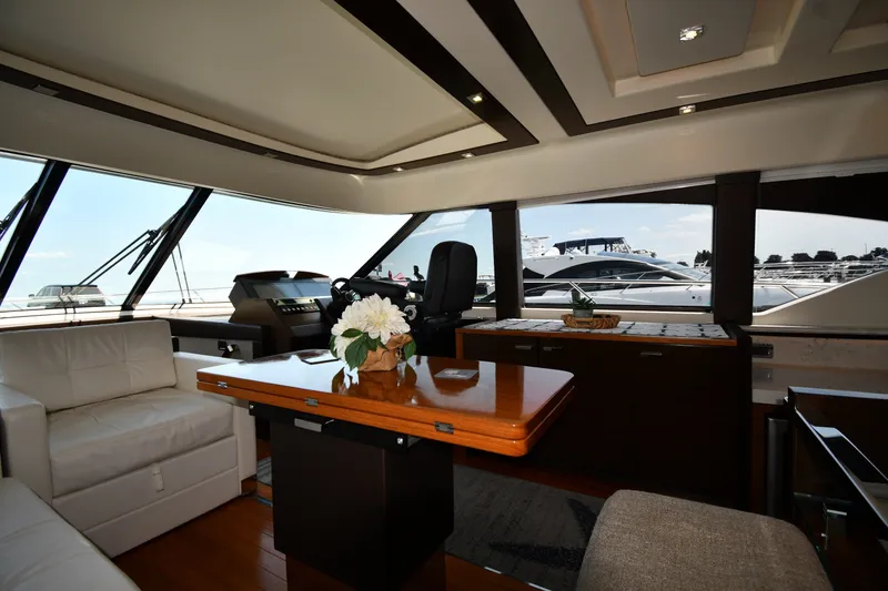Slide: The Image of Luxurious interior of 2016 Tiara Yachts 50 Coupe with elegant seating and panoramic windows. - 51