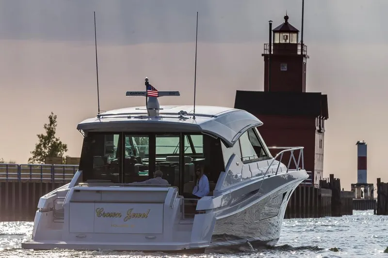 Slide: The Image of Manufacturer Provided Image: 2016 Tiara Yachts 50 Coupe cruising near a lighthouse at sunset. - 8