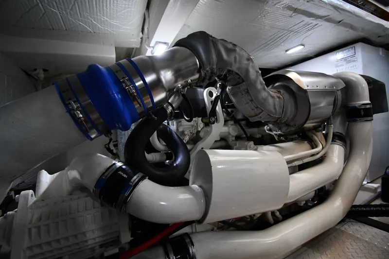 Slide: The Image of Engine room of a 2016 Tiara Yachts 50 Coupe, showcasing complex piping and components. - 65