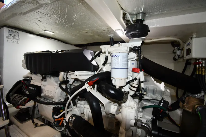 Slide: The Image of Engine room of 2016 Tiara Yachts 50 Coupe, featuring Volvo components and detailed mechanical setup. - 63