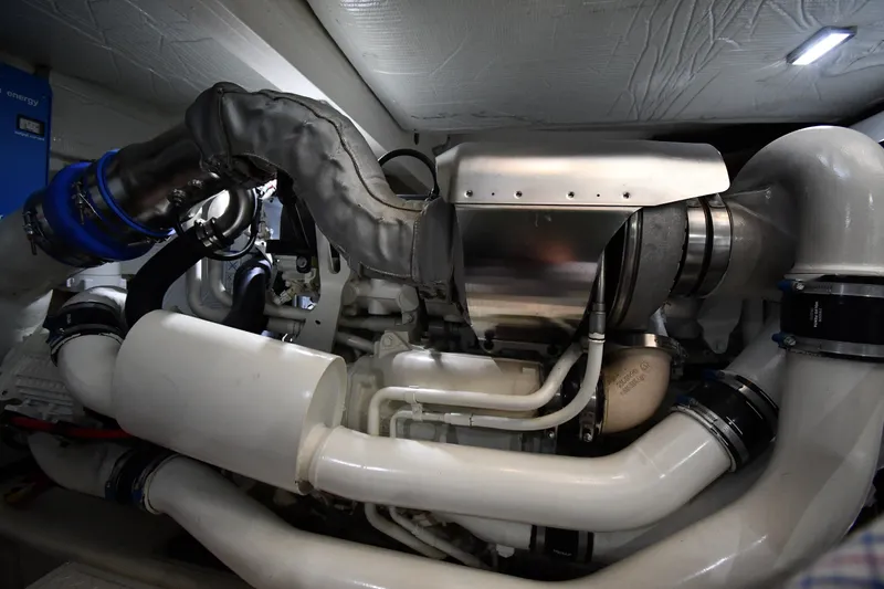 Slide: The Image of Engine room of 2016 Tiara Yachts 50 Coupe, showcasing complex machinery and components. - 66