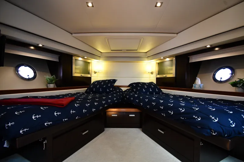 Slide: The Image of Luxurious 2016 Tiara Yachts 50 Coupe cabin with twin beds and nautical decor. - 24