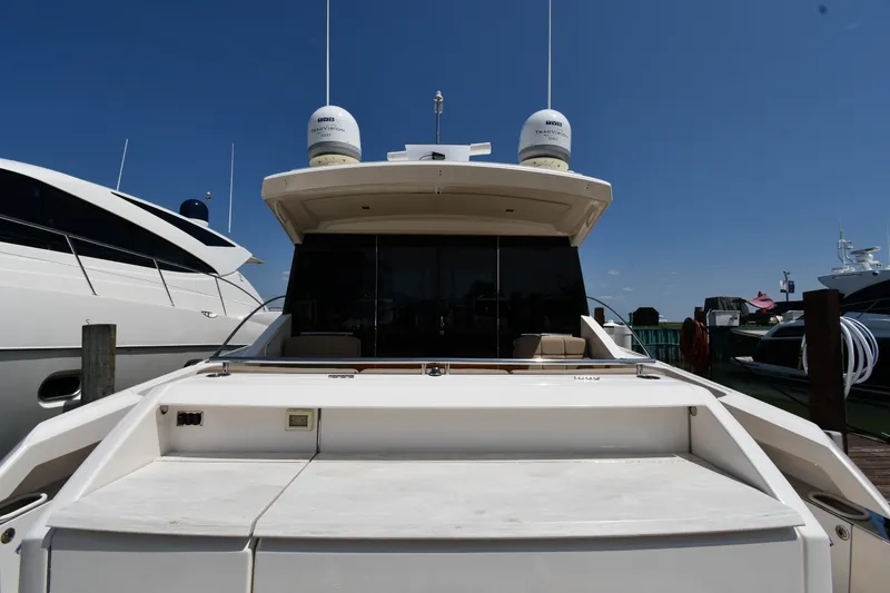 Slide: The Image of 2016 Tiara Yachts 50 Coupe docked, rear view under clear blue sky. - 10