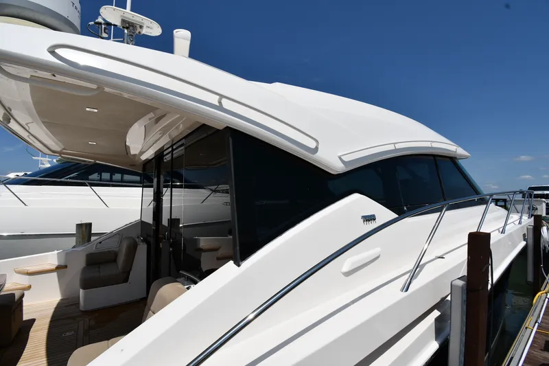 Slide: The Image of 2016 Tiara Yachts 50 Coupe docked, showcasing sleek design and luxurious seating. - 3