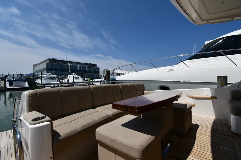 Slide: The Image of Luxurious 2016 Tiara Yachts 50 Coupe with elegant seating at marina dock. - 13
