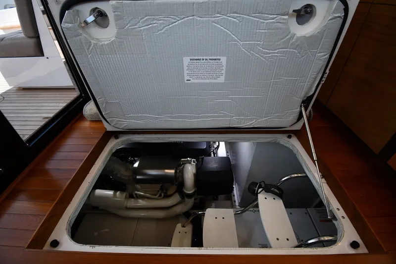 Slide: The Image of Engine compartment of a 2016 Tiara Yachts 50 Coupe, showcasing mechanical components. - 62