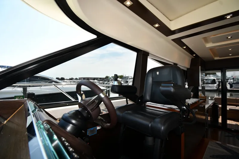 Slide: The Image of Interior view of 2016 Tiara Yachts 50 Coupe helm with luxurious seating and controls. - 57